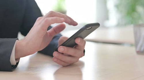 Close Up of Businessman Working on Smartphone