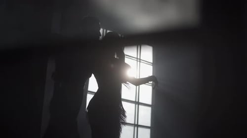 Silhouette of Couple Dancing in Bright Sunlight