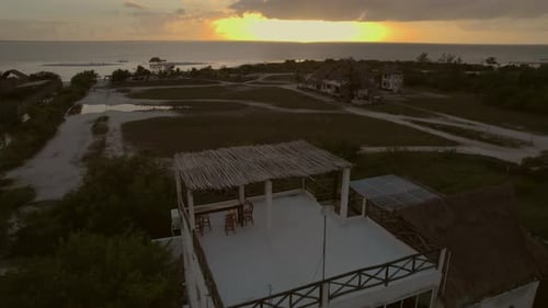 Drone aerial pan over villa accomodation hotel rooftop branch balcony garden courtyard with dining c