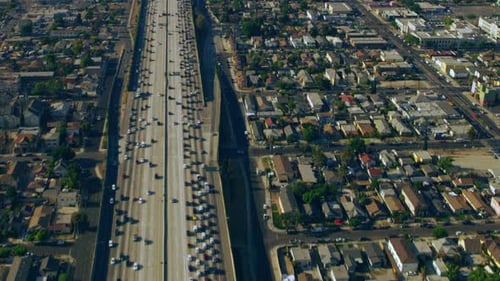 Los Angeles highway traffic flowing smoothly under a sunny California skyline