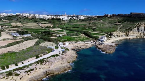 Aerial view of Gozo Malta featuring a serene story of Mediterranean life during spring where lush