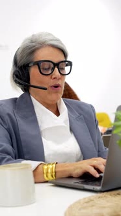 Mature Businesswoman Providing Customer Service at Call Center