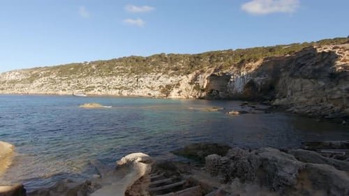 View of the cliffs and the sea on a beautiful sunny day. Punta de Ses Pedreres, Spain.