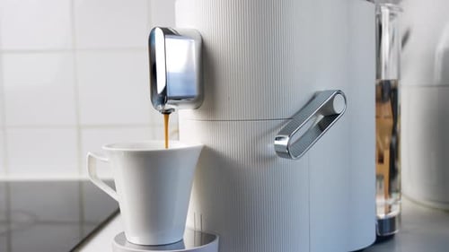 Close-up of a modern coffee machine making coffee.