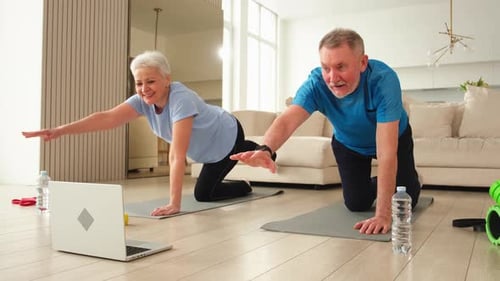 Active Senior Couple Exercising at Home