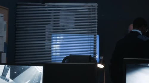 Men Working at Security Monitoring Station Late Night