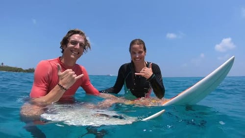 Young Adults Surfing in Tropical Paradise