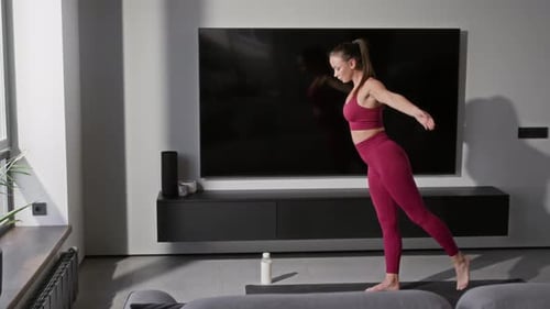Woman Practicing Balance Yoga Pose at Home