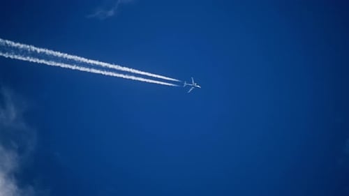 Airplane Flying in the Sky Leaving Contrails