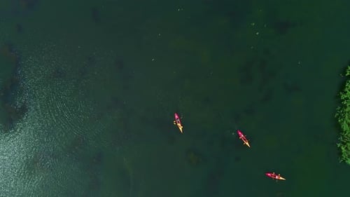 Aerial Drone Fly Above Tropical Green Sea Bay with Red Yellow Canoes Paddling