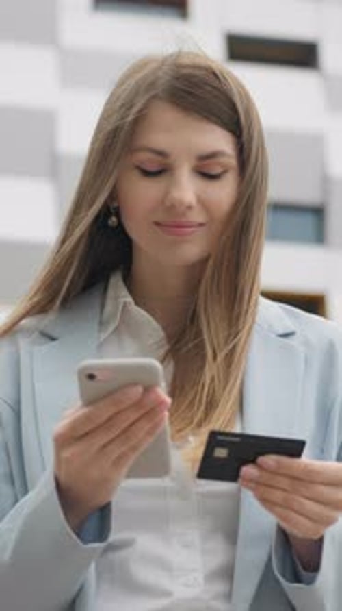Woman Using Phone with Credit Card Mobile Banking