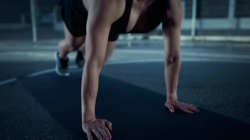 Beautiful Energetic Fitness Girl Doing Mountain Climber Exercises. She is Doing a Workout in a Fenc