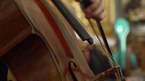 close up of cello being played in elegant setting