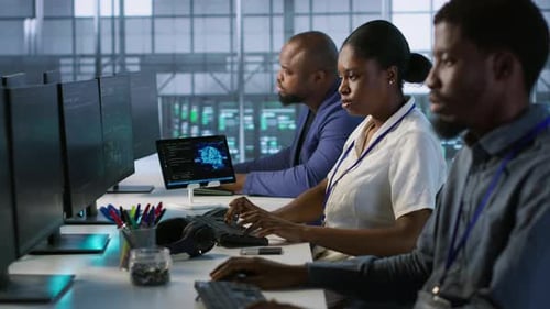 Technicians Using Computers and Tablet in Data Center Implementing AI