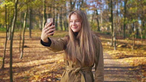Stylish Lady Wearing Fashionable Clothes Walking in Park in Autumn