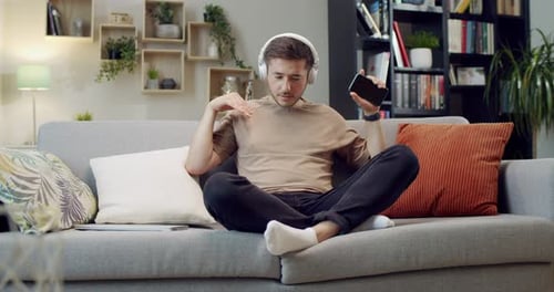 Man Enjoying Music With Headphones at Home