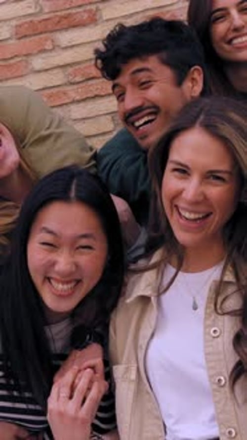 Group of Young Adults Laughing Together in City