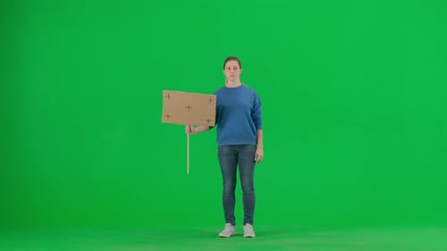 A Sad Female Activist Holds Up a Blank Sign on a Green Screen Chroma Key Advertisement Promo