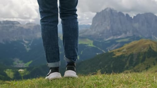Tourist Walks on Green Meadow with View of Mountain Valley