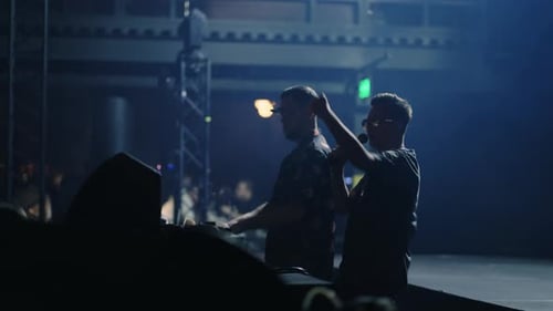 Concert Of Trendy DJ In Modern Nightclub DJ Mixing Tracks For Dancing And Host Man Rocking Crowd
