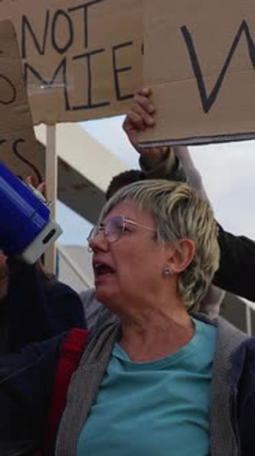 Activists Protesting Against War Holding Signs and Megaphones