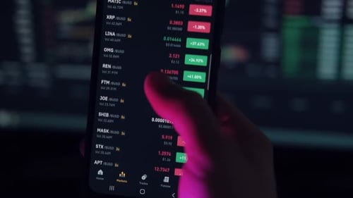 Person Scrolls Through Stocks on Trading App