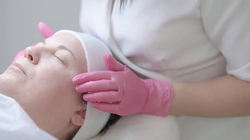 Cosmetologist Expertly Performs Facial Procedures on Client at Aesthetic Clinic Including Peeling