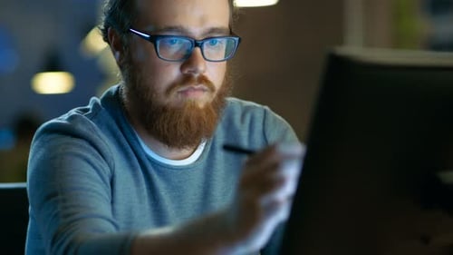 Talented Young Concept Artist Drawing on a Digital Pen Display Tablet While Sitting at His Working