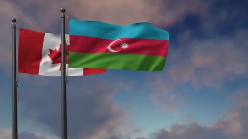 Waving Flags of Canada and Azerbaijan Against a Blue Sky