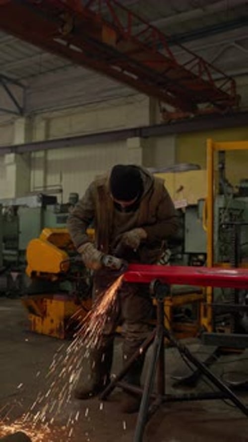 Worker Grinding Metal Beam with Grinding Machine Metallurgical Production Concept