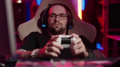 Gamer Playing Video Games in Colorful Room at Night