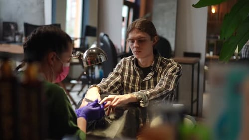 Young Adult Gets Manicure at Nail Salon