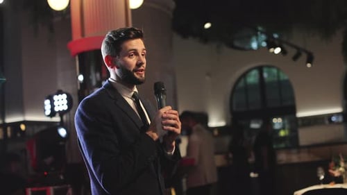 Man Speaking Into Microphone at Corporate Event