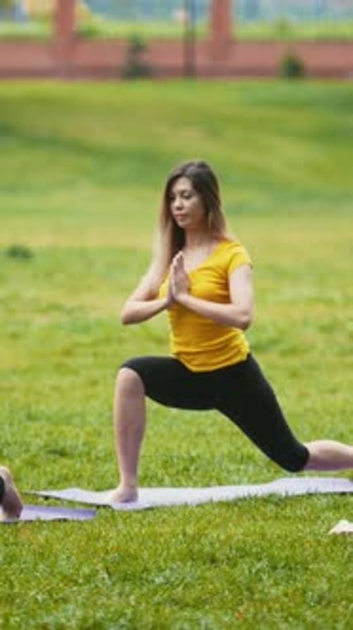 Yoga Training in Park Group of Sportsmen Perform Flexibility Exercise