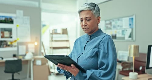 Mature, business woman and scroll on tablet in office for planning research