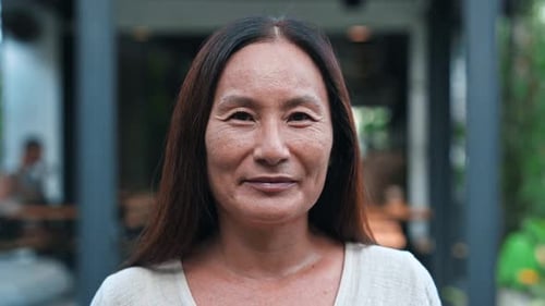 Happy Portrait of Matured Asian Woman Looking at Camera with Beautiful Smile