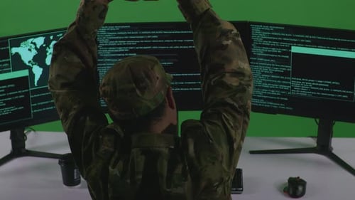 Tired Asian Man Soldier Stretching While Write Code With Multiple Computer Screens In Green Screen