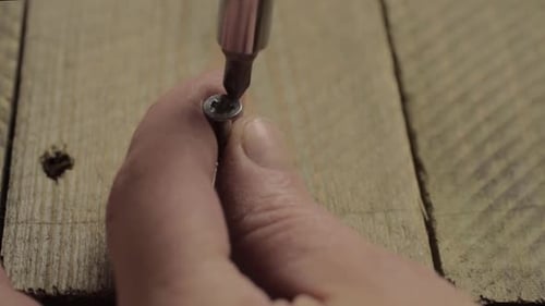 Hand Tightening Screw Into Wood Plank