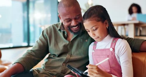 Father and Child Drawing Together on Tablet at Home