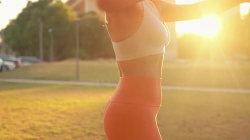 Woman Exercising with Resistance Band in Park