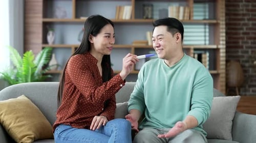 Excited Couple Celebrate Positive Pregnancy Test at Home