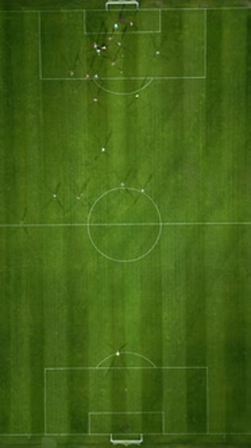 Aerial View of a Soccer Field in Action with Players Running Passing and Scoring Goals
