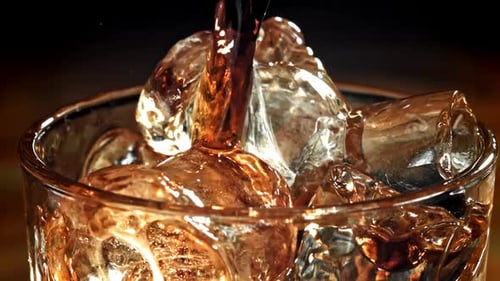 Pouring Beverage Over Ice Cubes Close-Up
