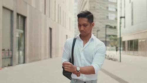 Young businessman walking through the business district