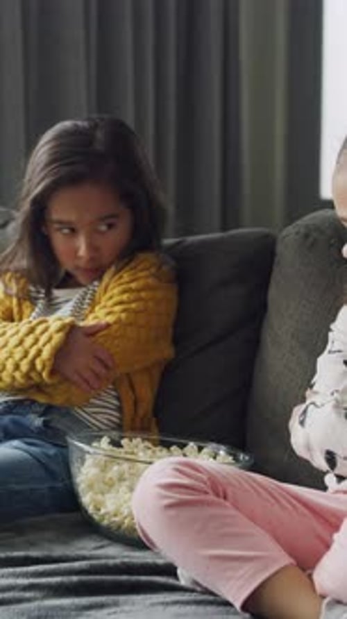 Popcorn, upset and children in home with argument, sad or disagreement in living room