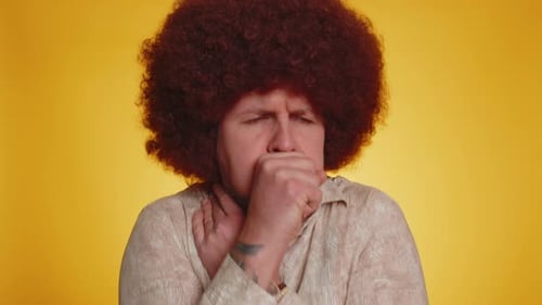 Man with Afro Coughing and Clutching Throat