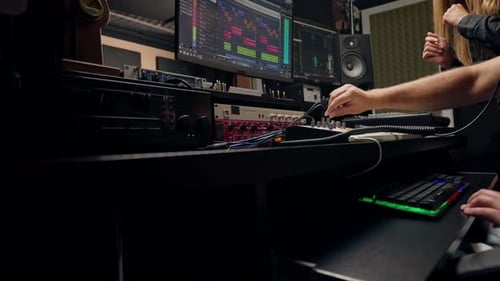 On the sound engineer's computer monitor sound tracks for mixing a new soundtrack that girl sings