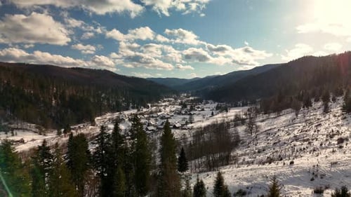 Winter Village in Mountain Valley Aerial View
