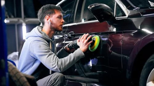 the Car Mechanic at a Service Station Doing the Final Polishing to Shine