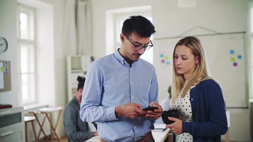 Young business team collaborating with a smartphone in a modern office space
